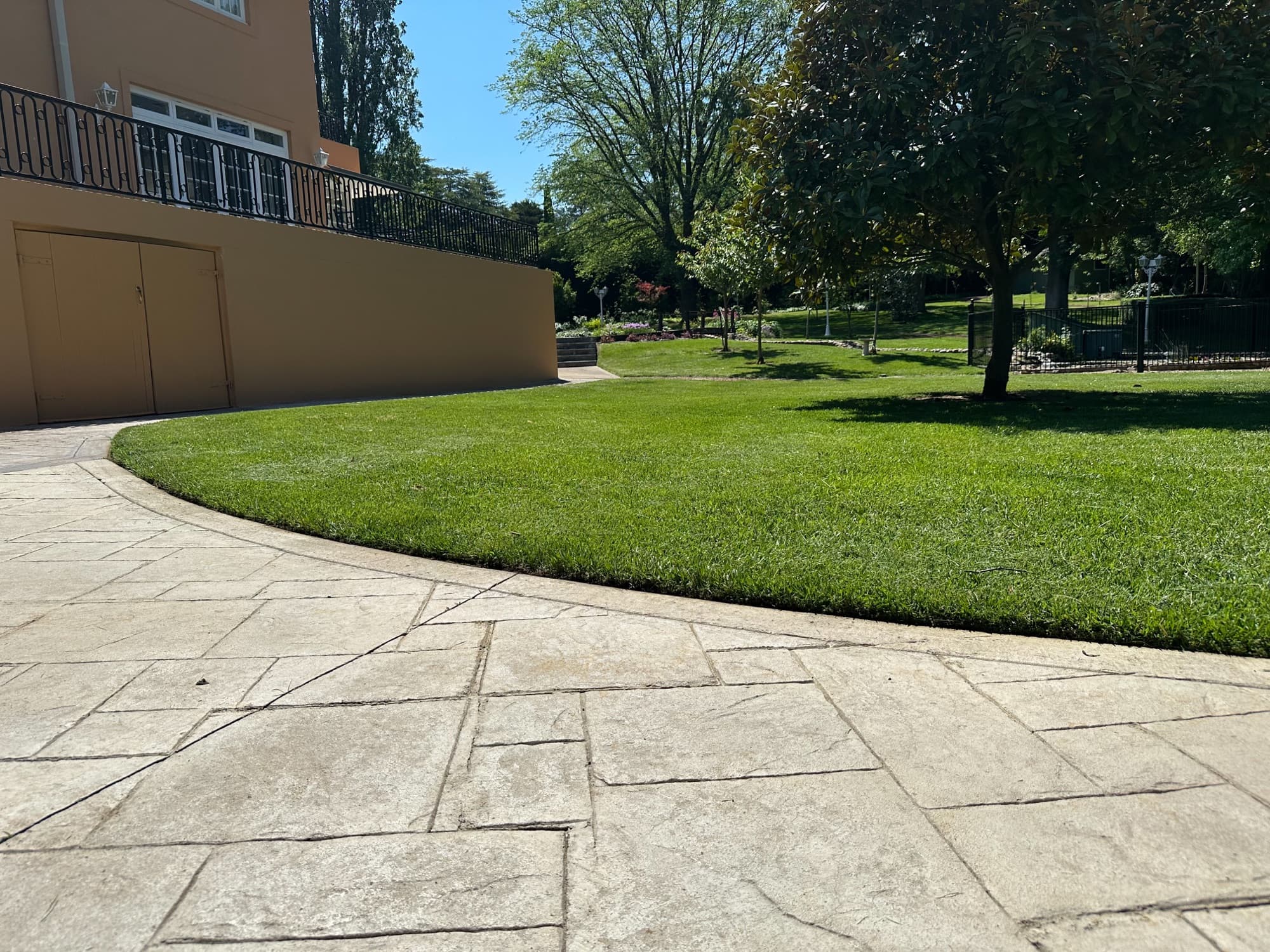 Clean lawn edge curving along a stone path